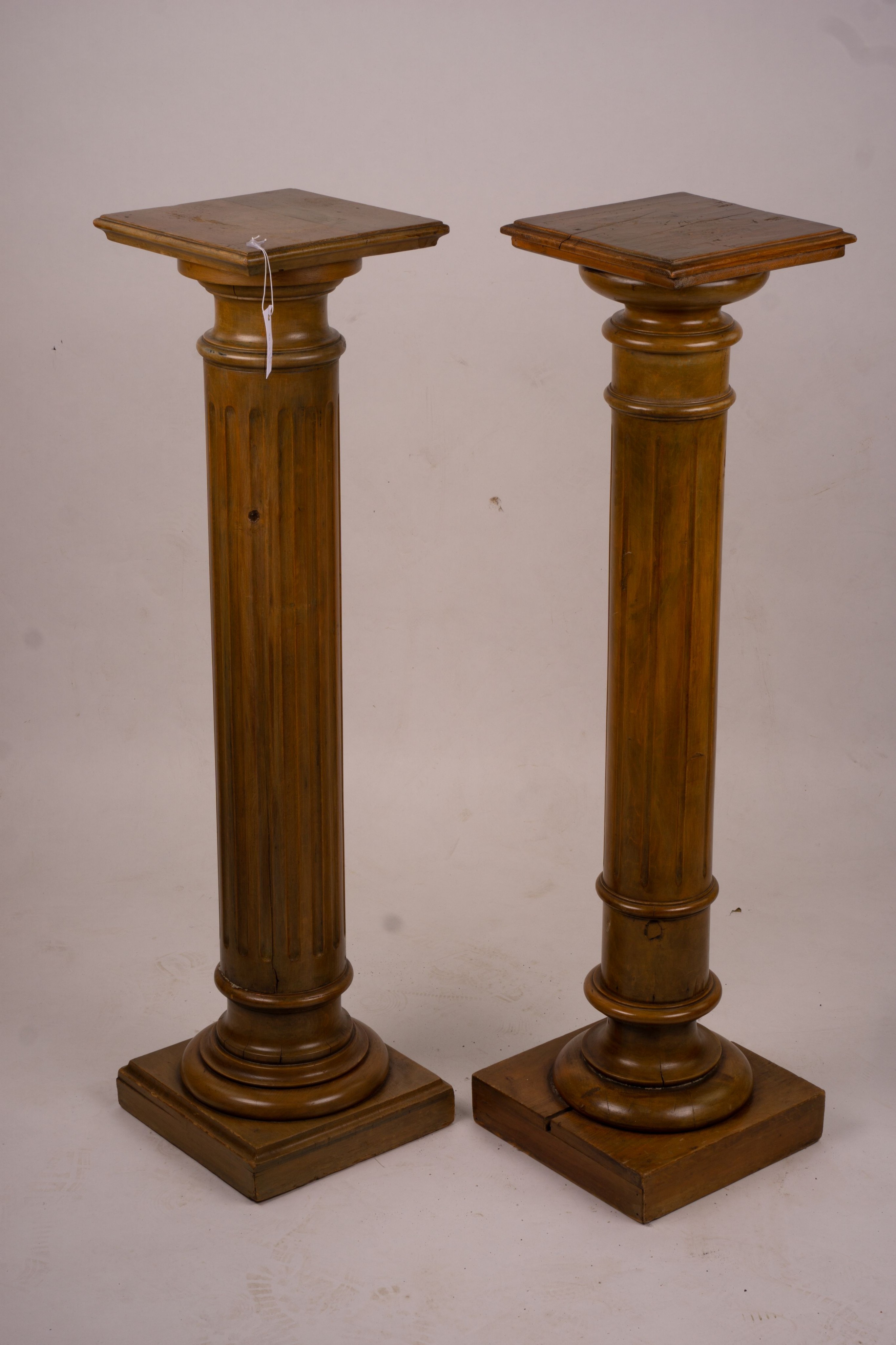 A pair of Victorian style carved beech and walnut pedestals, height 110cm